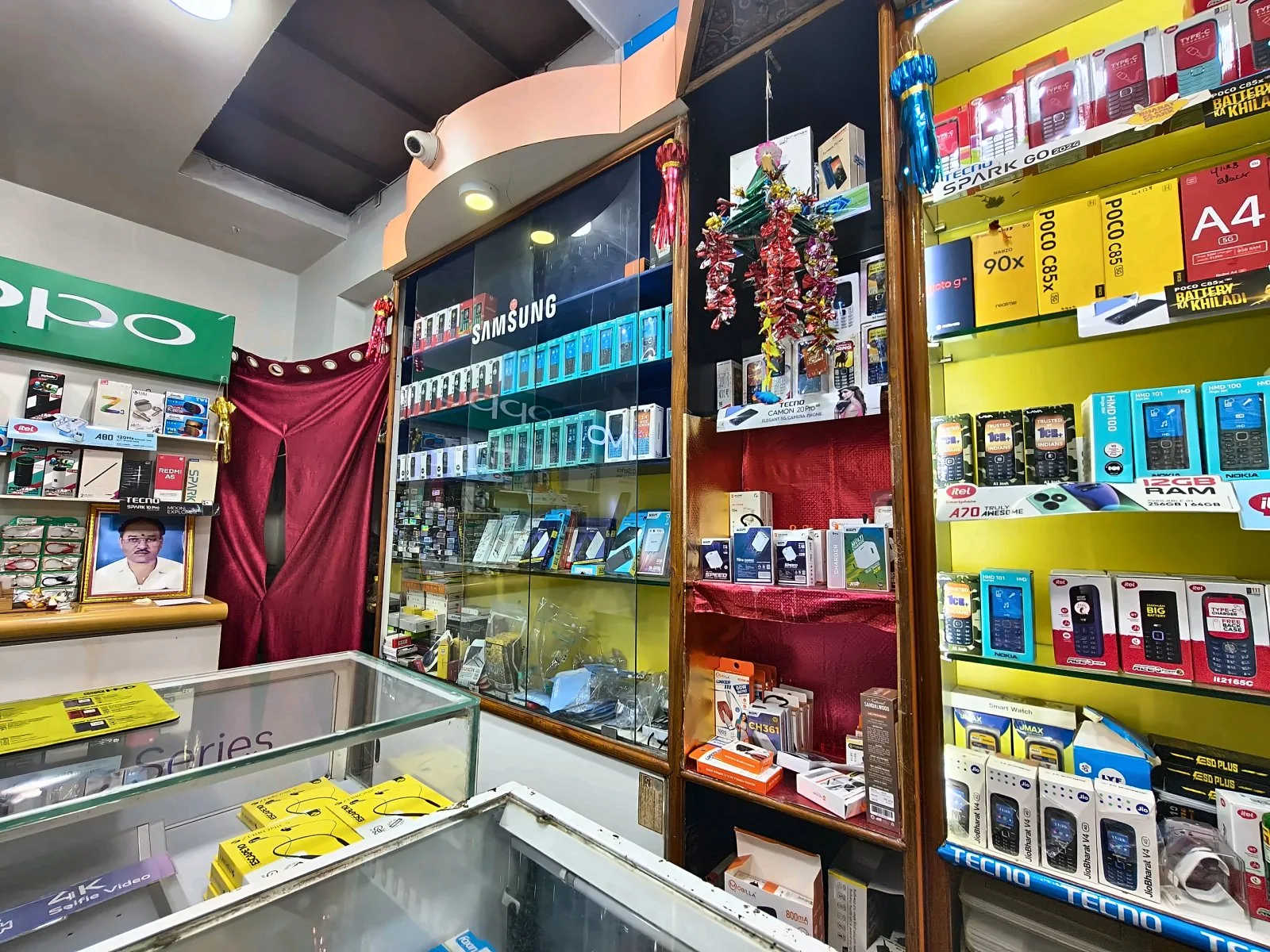 Glass phone counters and multiple brand displays inside Anand Watch And Mobiles
