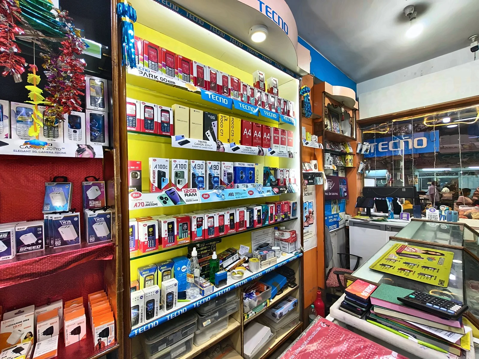 Phone accessories and device boxes displayed in the Gadag shop